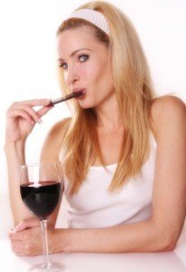 Woman eating chocolate and wine